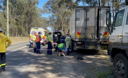 Man is being moved off of the road by medical staff