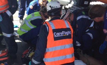 Doctors working with nurses to help injured construction patient
