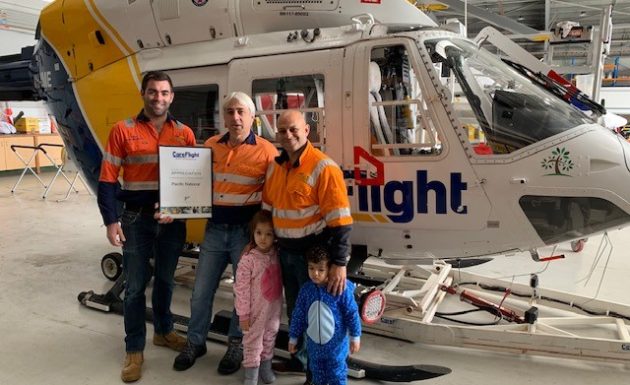 People in front of CareFlight helicopter